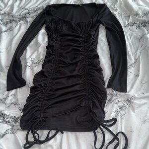 Black Shein size small mini dress with long sleeves and ruched sides, with ties